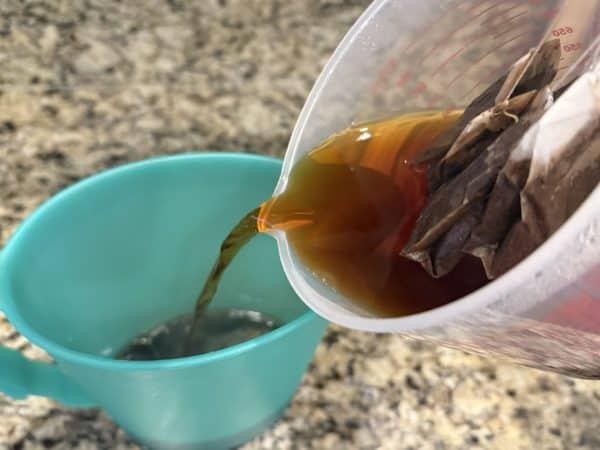Southern Sweet Tea Recipe pour tea into pitcher