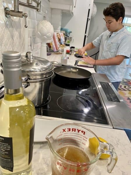 Britton Cone cooks shrimp scampi in kitchen