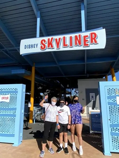 skyliner sign with mom and kids