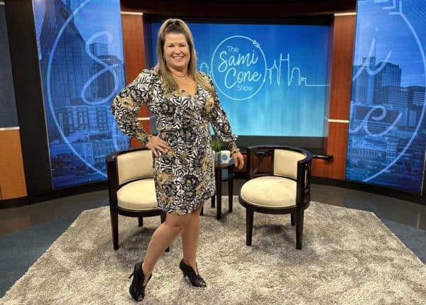 Sami Cone on set at The Sami Cone Show December 2022 in Lilly Pulitzer black and tan dress
